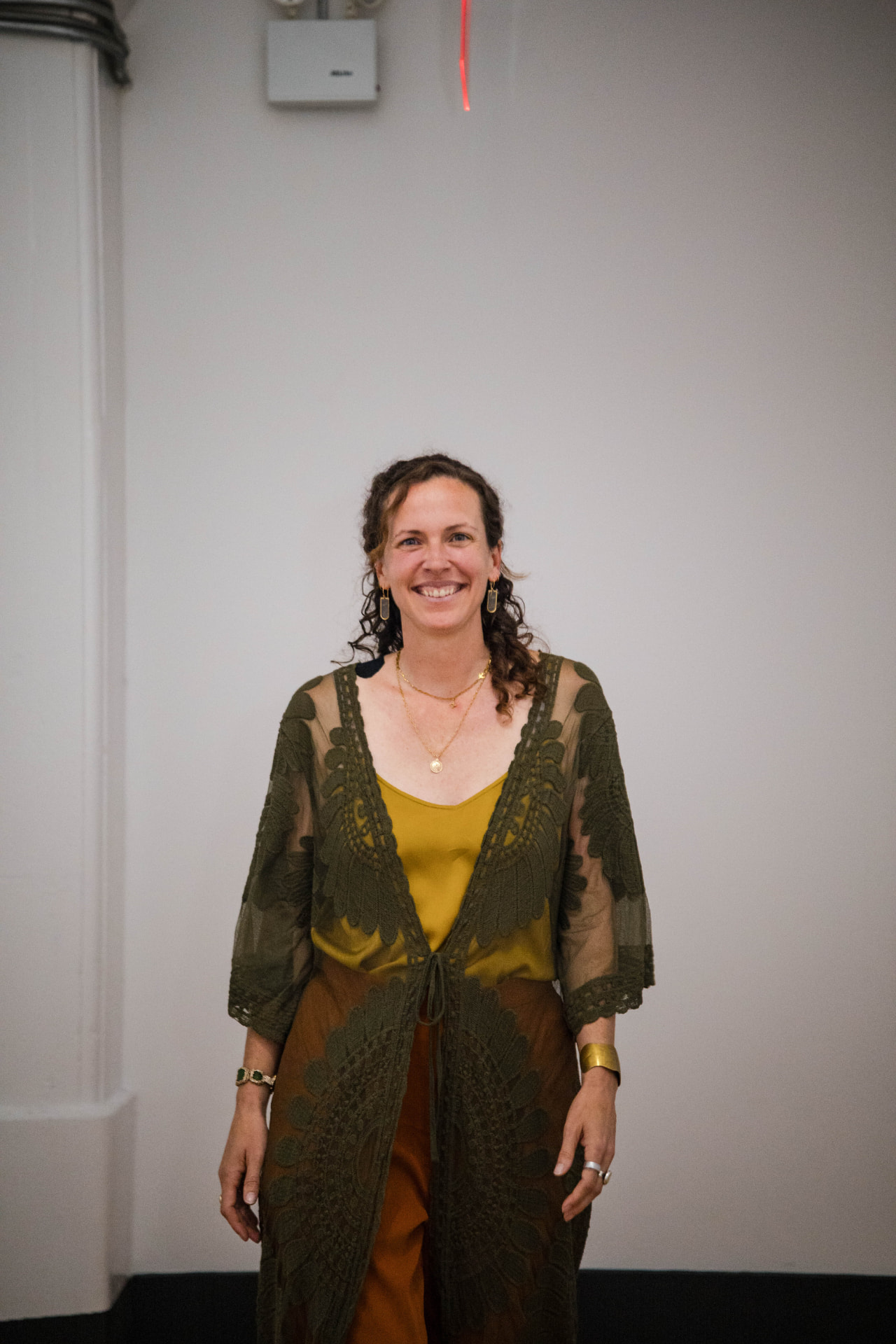 Brittany Martin Déjean in an olive lace kimono, smiling
