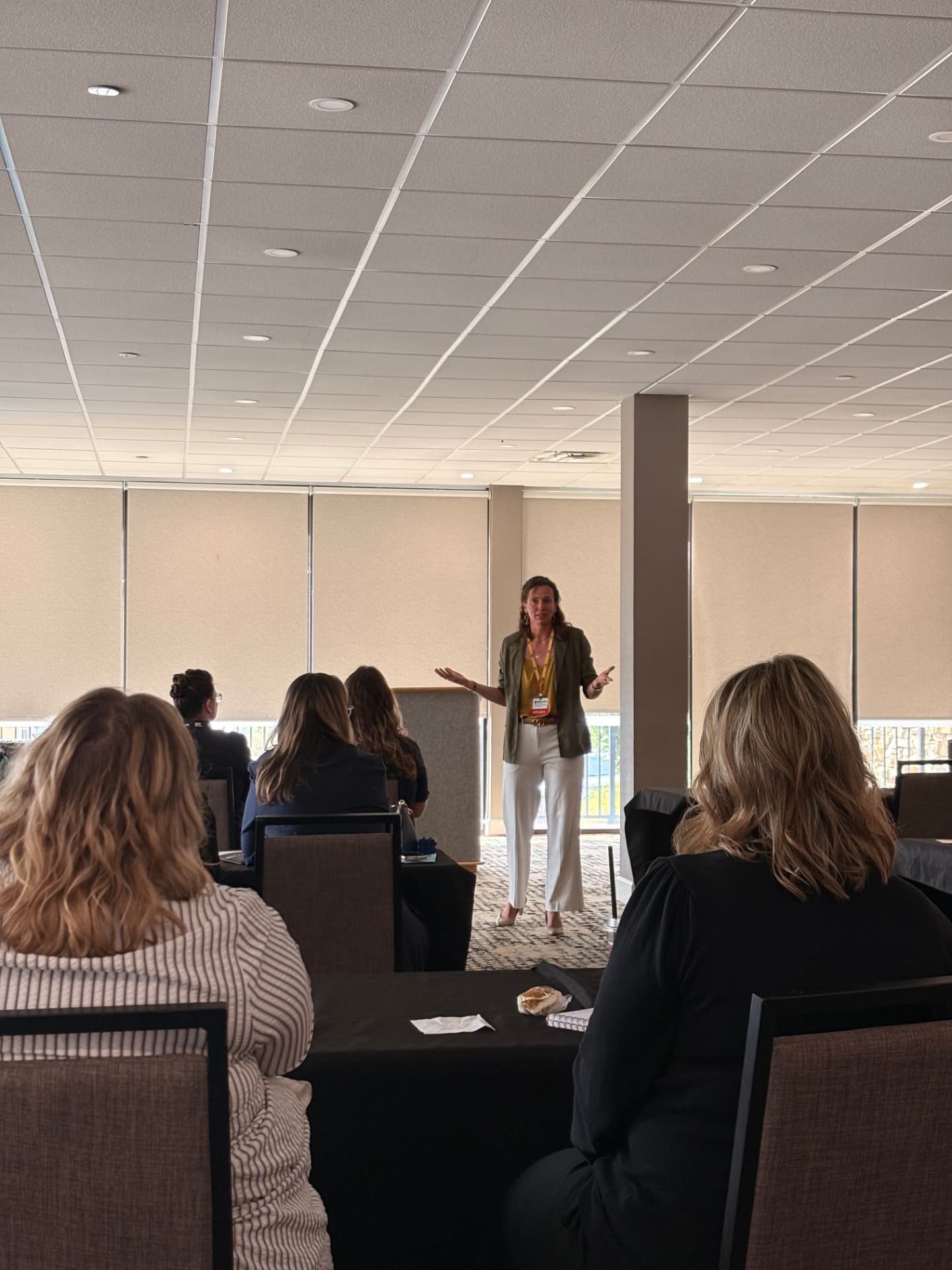 Brittany Martin Déjean speaking to a room of seated attendees